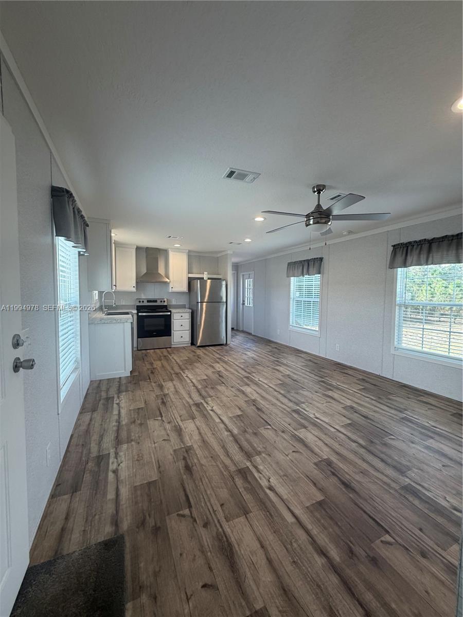 130 North Granja Street Clewiston, FL 33440 - Photo 2 of 10 a view of empty room with wooden floor and window