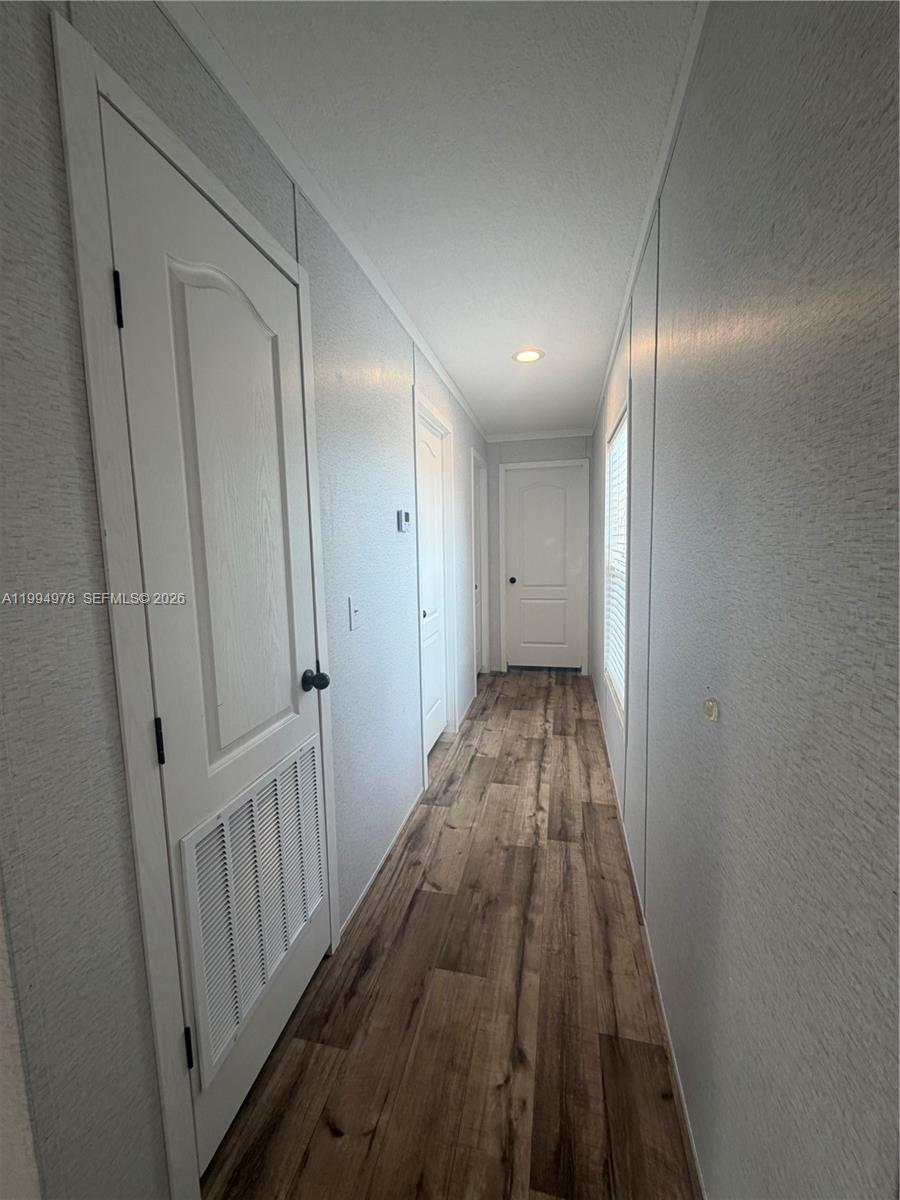 130 North Granja Street Clewiston, FL 33440 - Photo 5 of 10 a view of hallway with wooden floor