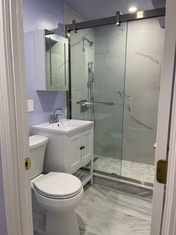 a bathroom with a sink toilet and shower
