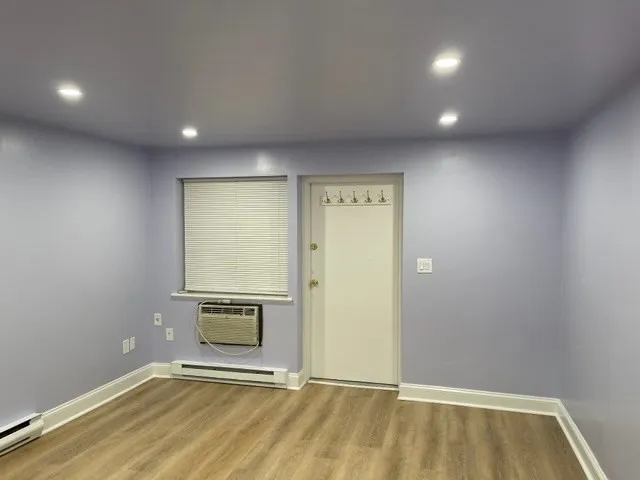 an empty room with wooden floor and a empty room