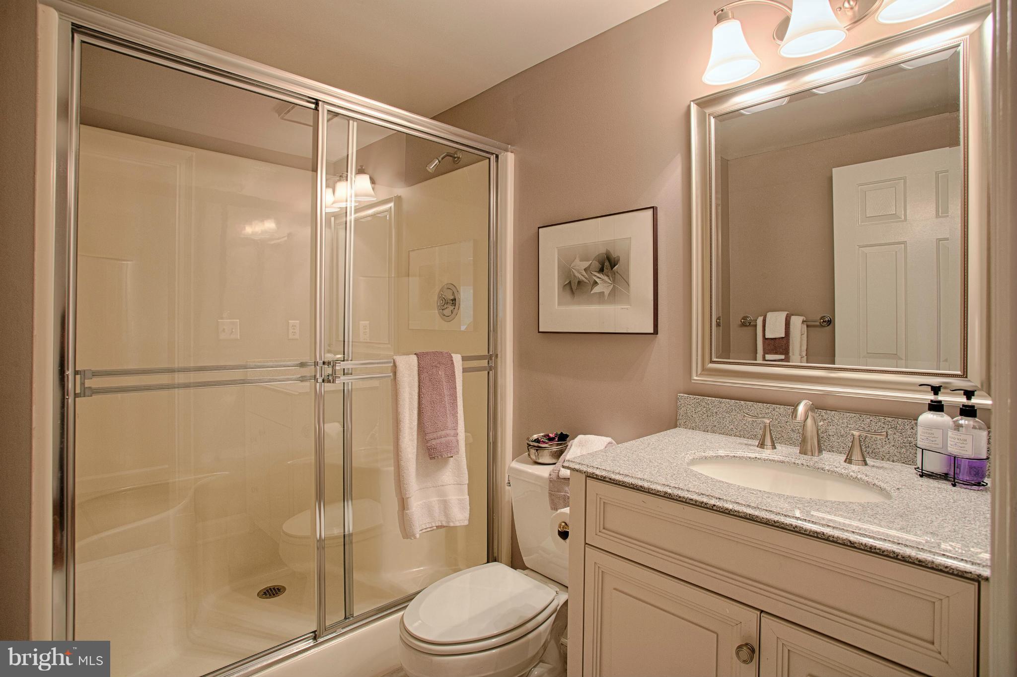 11311 Fieldstone Lane Reston, VA 20191 - Photo 11 of 30 a bathroom with a granite countertop sink toilet and shower