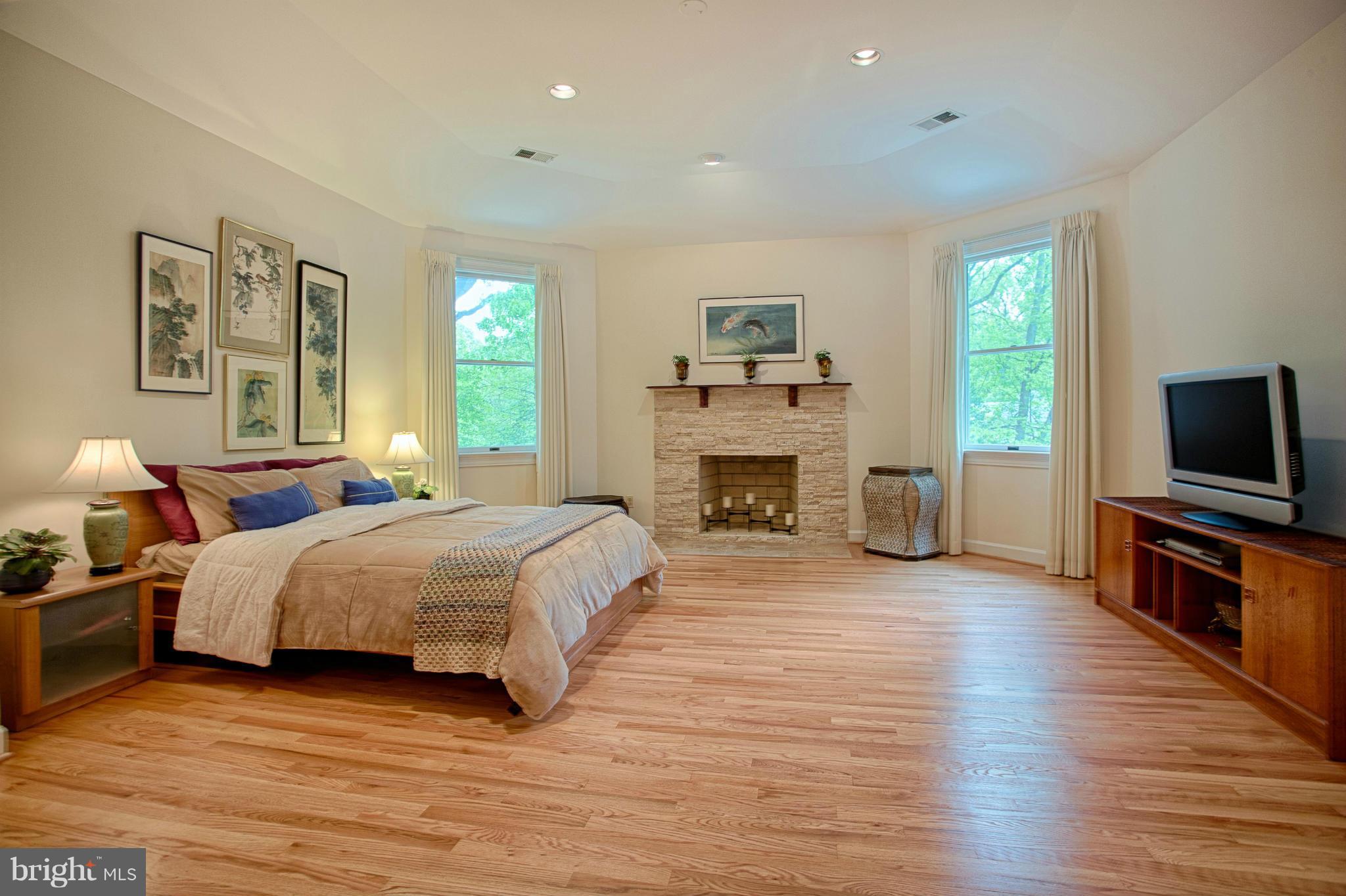 11311 Fieldstone Lane Reston, VA 20191 - Photo 13 of 30 a spacious bedroom with a bed and a flat screen tv