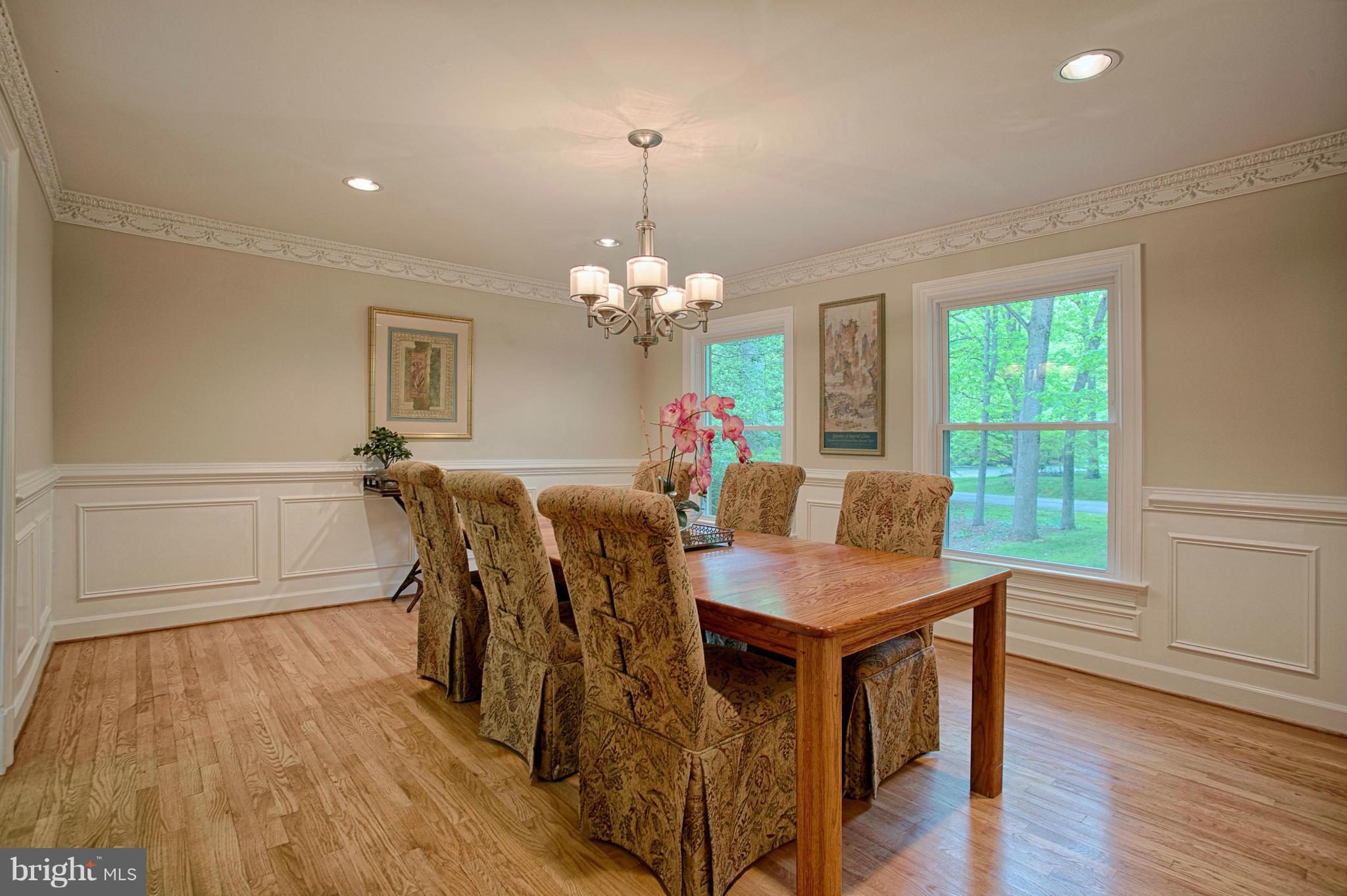 11311 Fieldstone Lane Reston, VA 20191 - Photo 5 of 30 a view of a dining room with furniture a chandelier and wooden floor