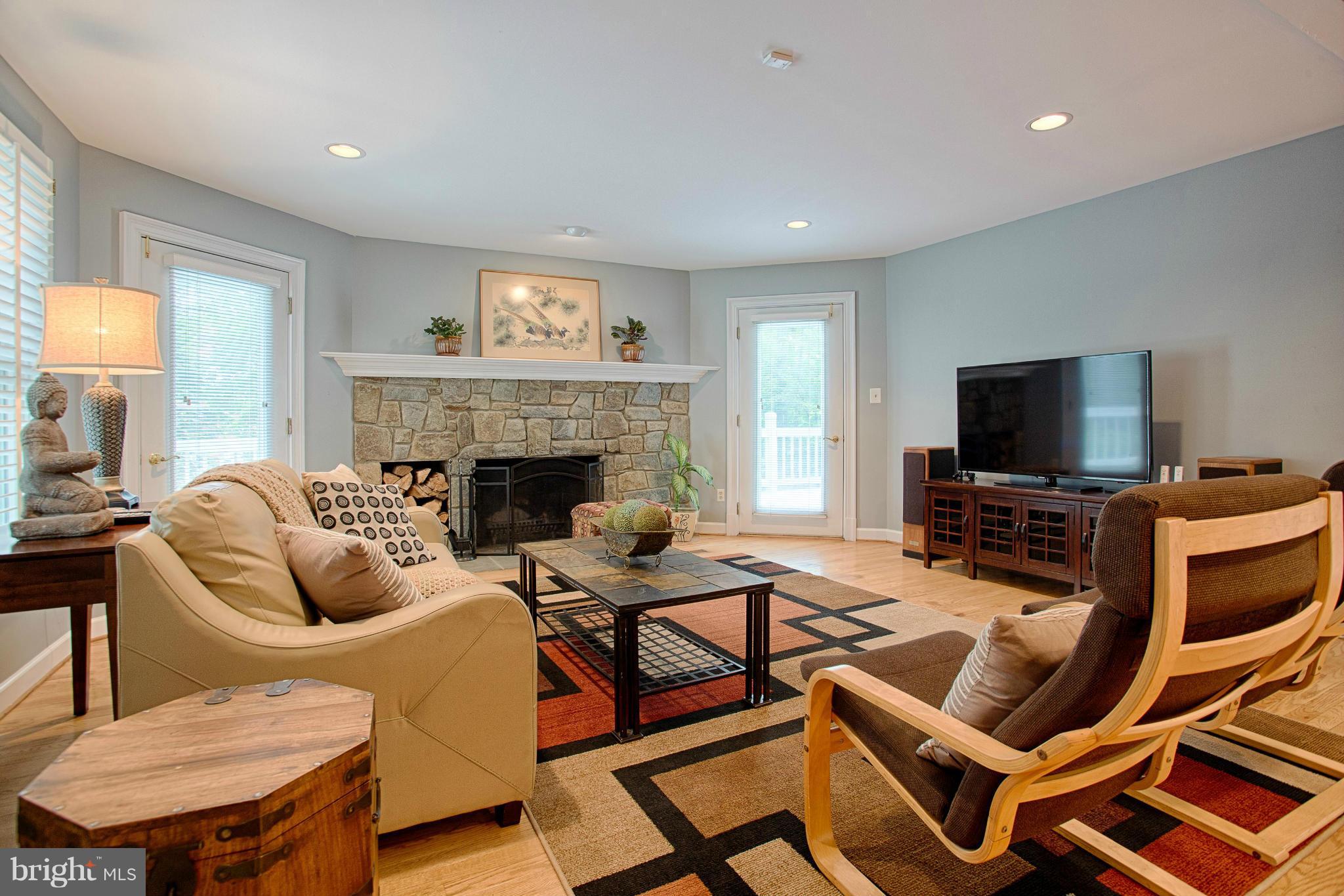 11311 Fieldstone Lane Reston, VA 20191 - Photo 8 of 30 a living room with furniture a flat screen tv and a fireplace