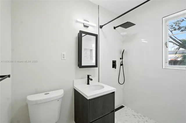 a bathroom with a sink a toilet and a mirror