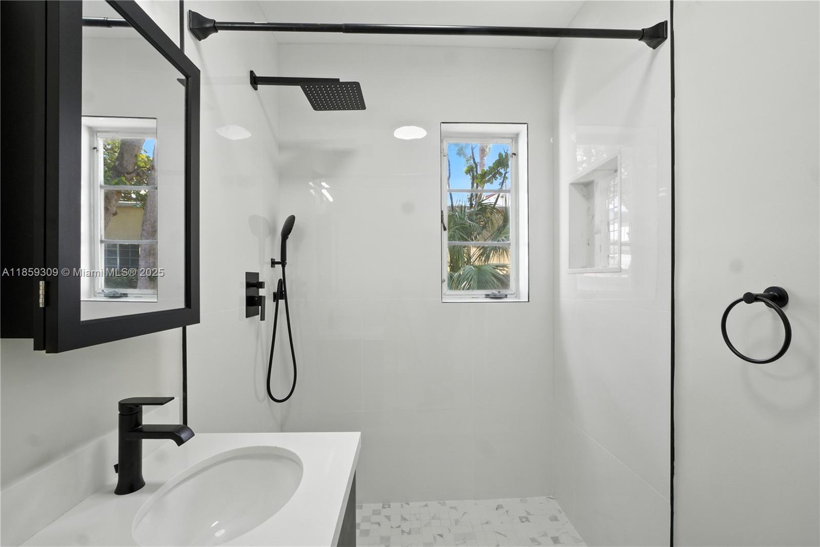 2545 Southwest 27th Lane Miami, FL 33133 - Photo 15 of 26 a bathroom with a sink and mirror