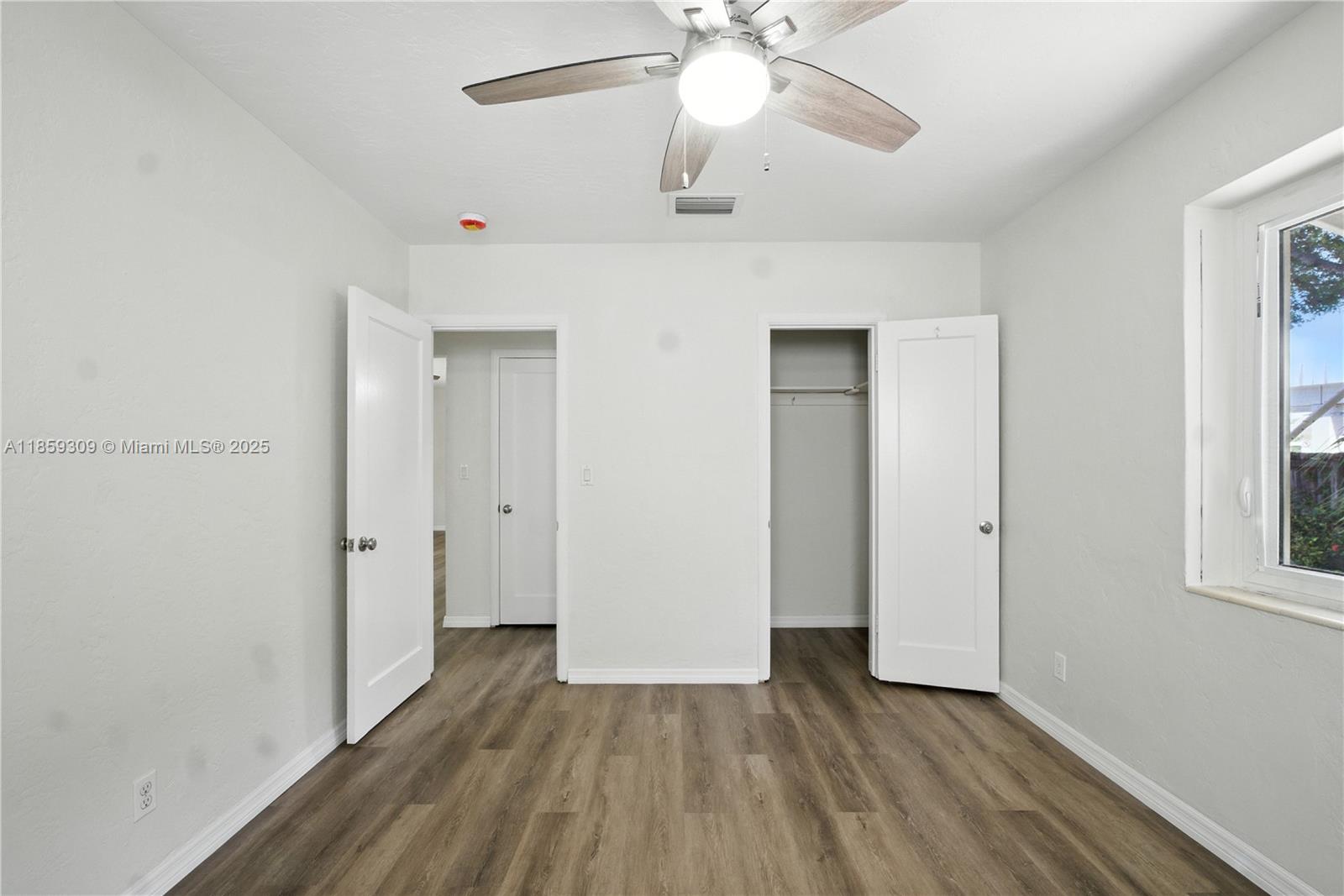 2545 Southwest 27th Lane Miami, FL 33133 - Photo 16 of 26 a view of an empty room with wooden floor and a window