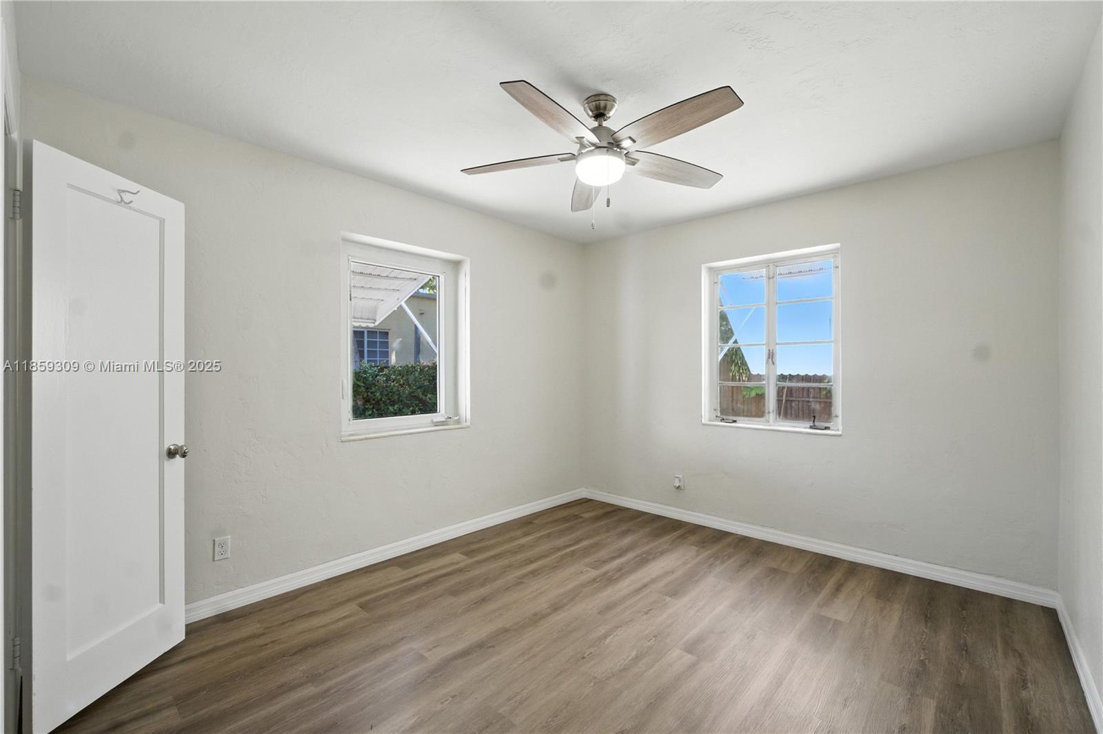2545 Southwest 27th Lane Miami, FL 33133 - Photo 19 of 26 a view of a big room with wooden floor closet and windows