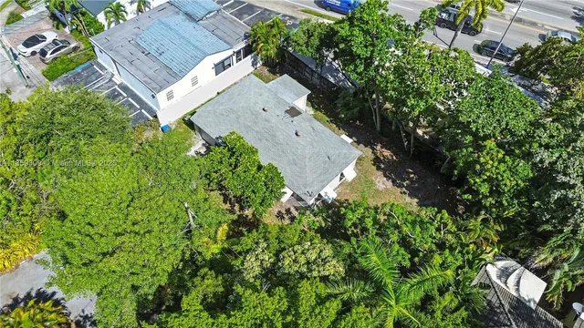 an aerial view of a house with a yard