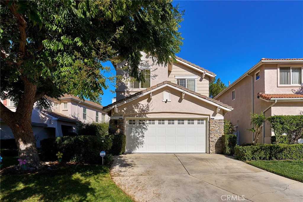 25553 Fitzgerald Avenue Stevenson Ranch, CA 91381 - Photo 2 of 40 a front view of a house with a yard and garage