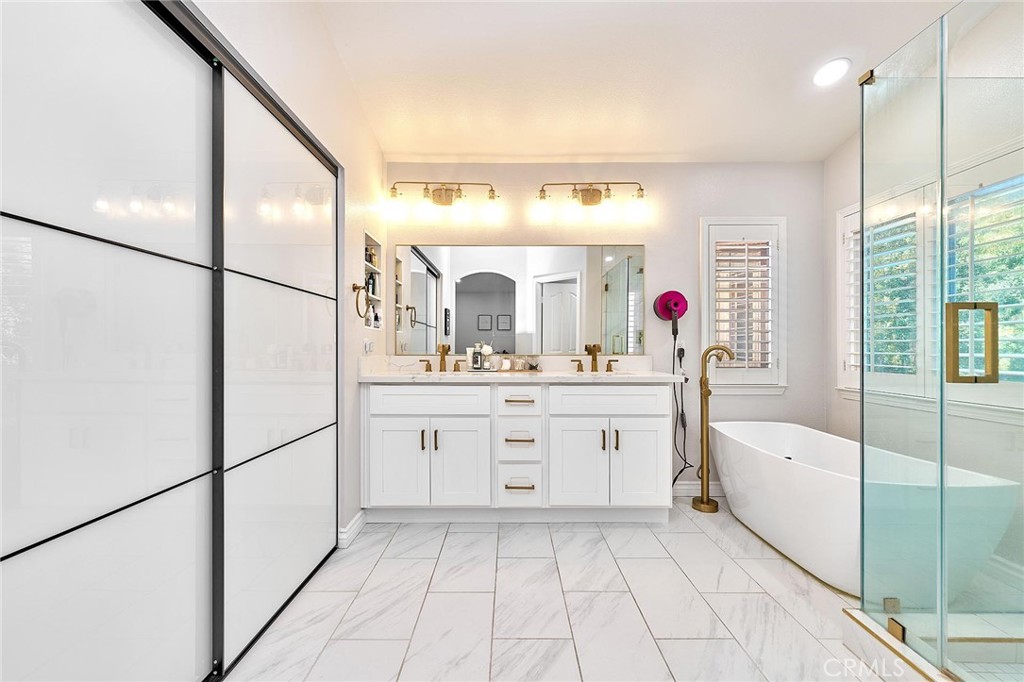 25553 Fitzgerald Avenue Stevenson Ranch, CA 91381 - Photo 27 of 40 a bathroom with a sink vanity and mirror