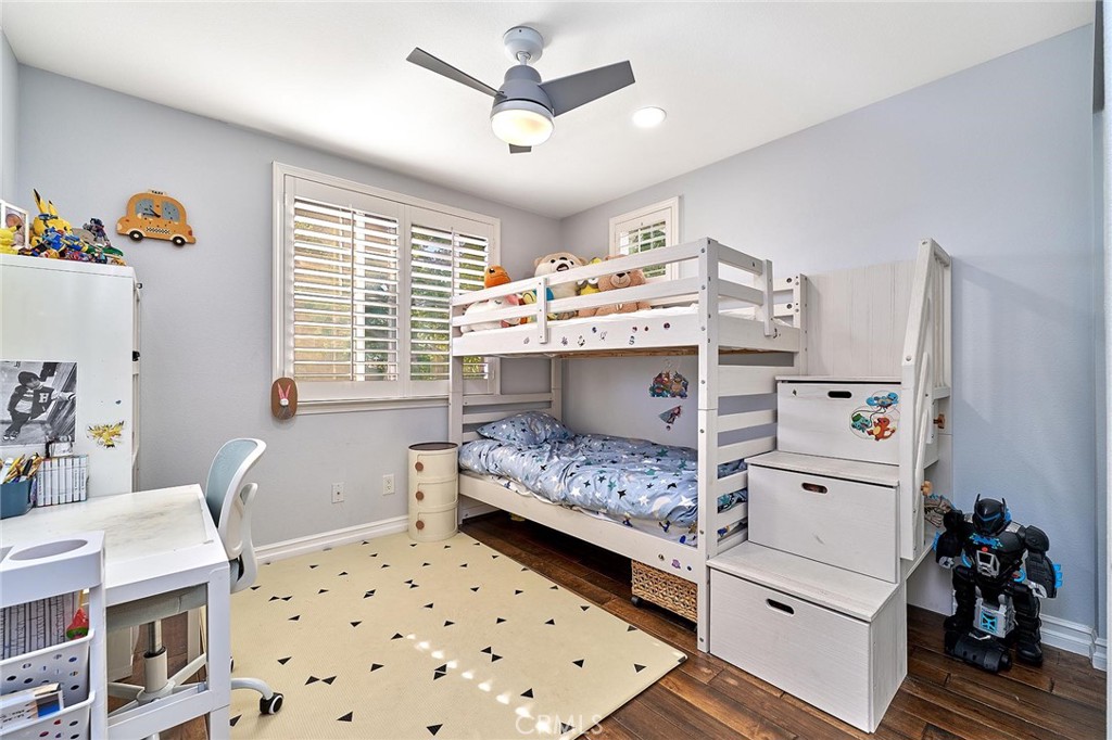 25553 Fitzgerald Avenue Stevenson Ranch, CA 91381 - Photo 33 of 40 a bedroom with a bed and a chandelier
