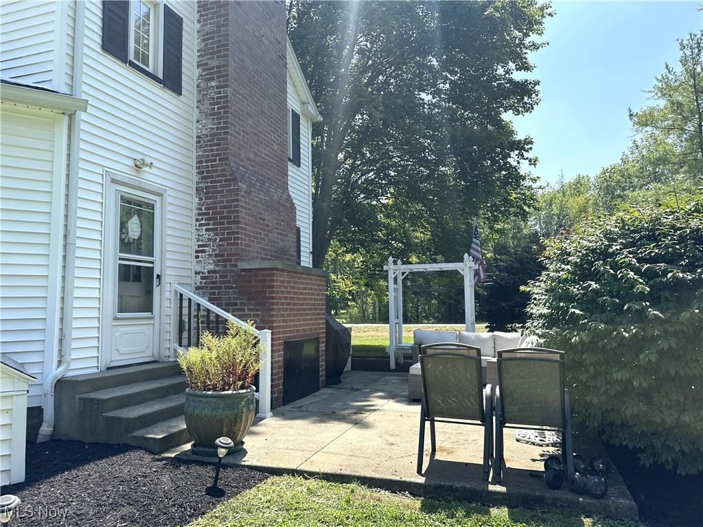 1568 State Road Northwest Warren, OH 44481 - Photo 29 of 30 View of property exterior featuring a chimney, entry steps, and an outdoor hangout area
