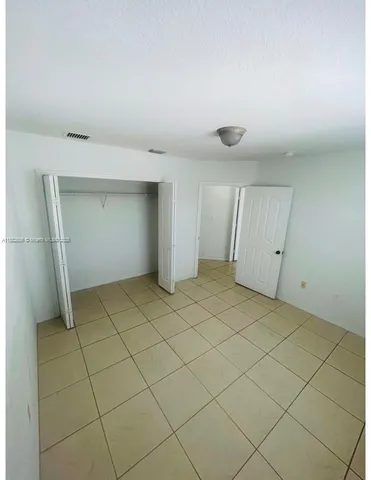 a view of an empty room and a window