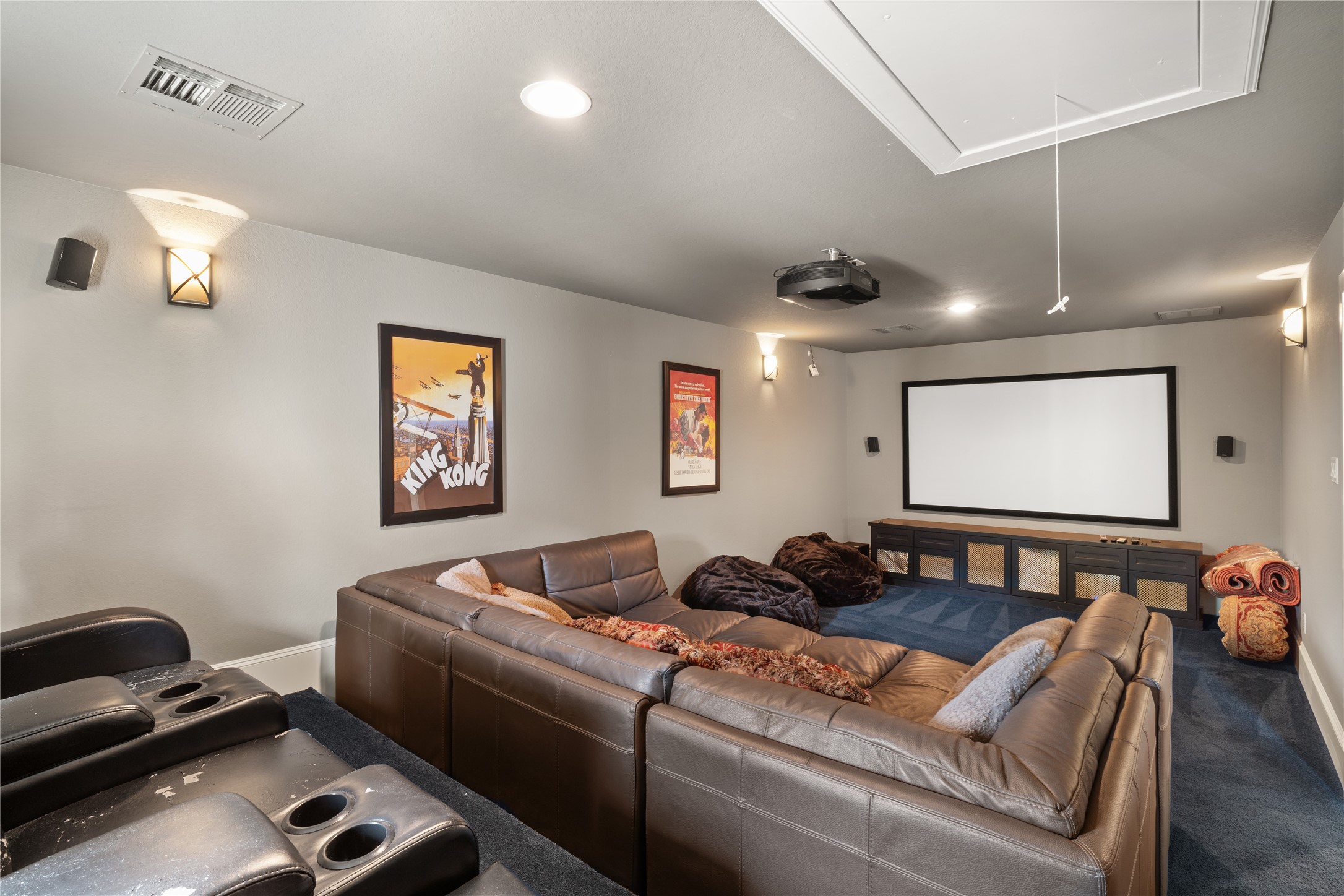 36 Wind River Drive Conroe, TX 77384 - Photo 41 of 45 A view towards the movie screen. The room features modern lighting, a projector, and movie-themed decor, creating an ideal space for entertainment and relaxation.