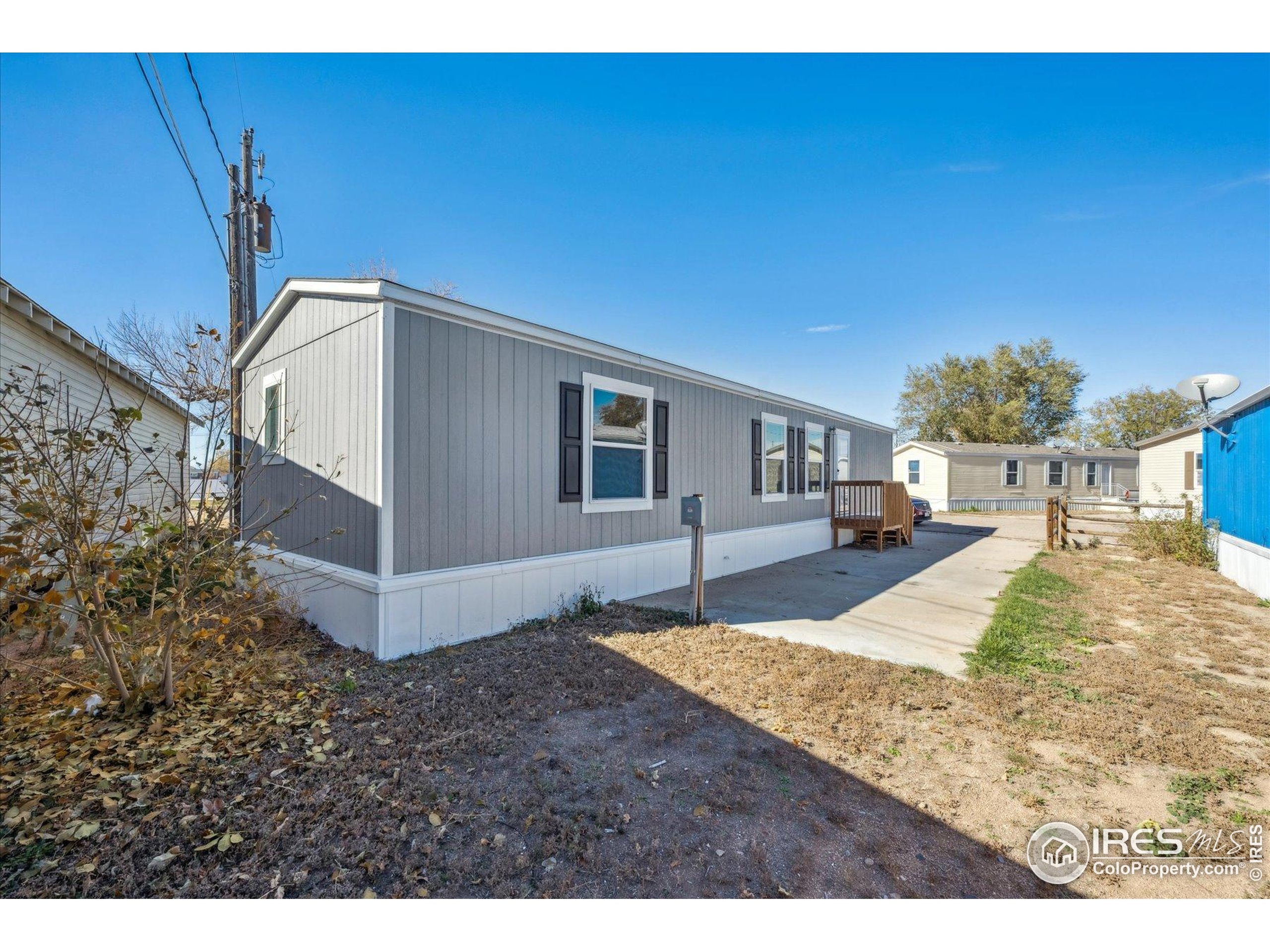 830 1st Street, Unit 2 Pierce, CO 80650 - Photo 1 of 16 a view of a house with backyard and trees