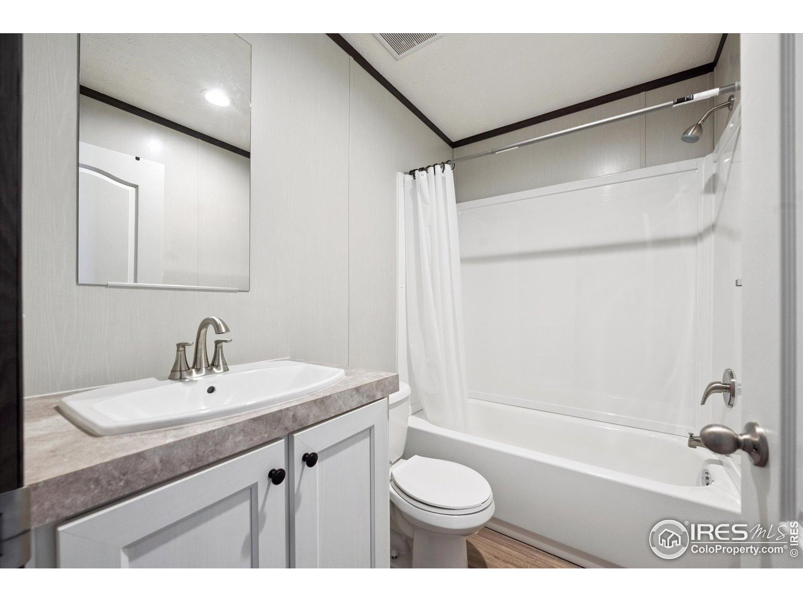 830 1st Street, Unit 2 Pierce, CO 80650 - Photo 14 of 16 a bathroom with a sink a toilet and a bathtub