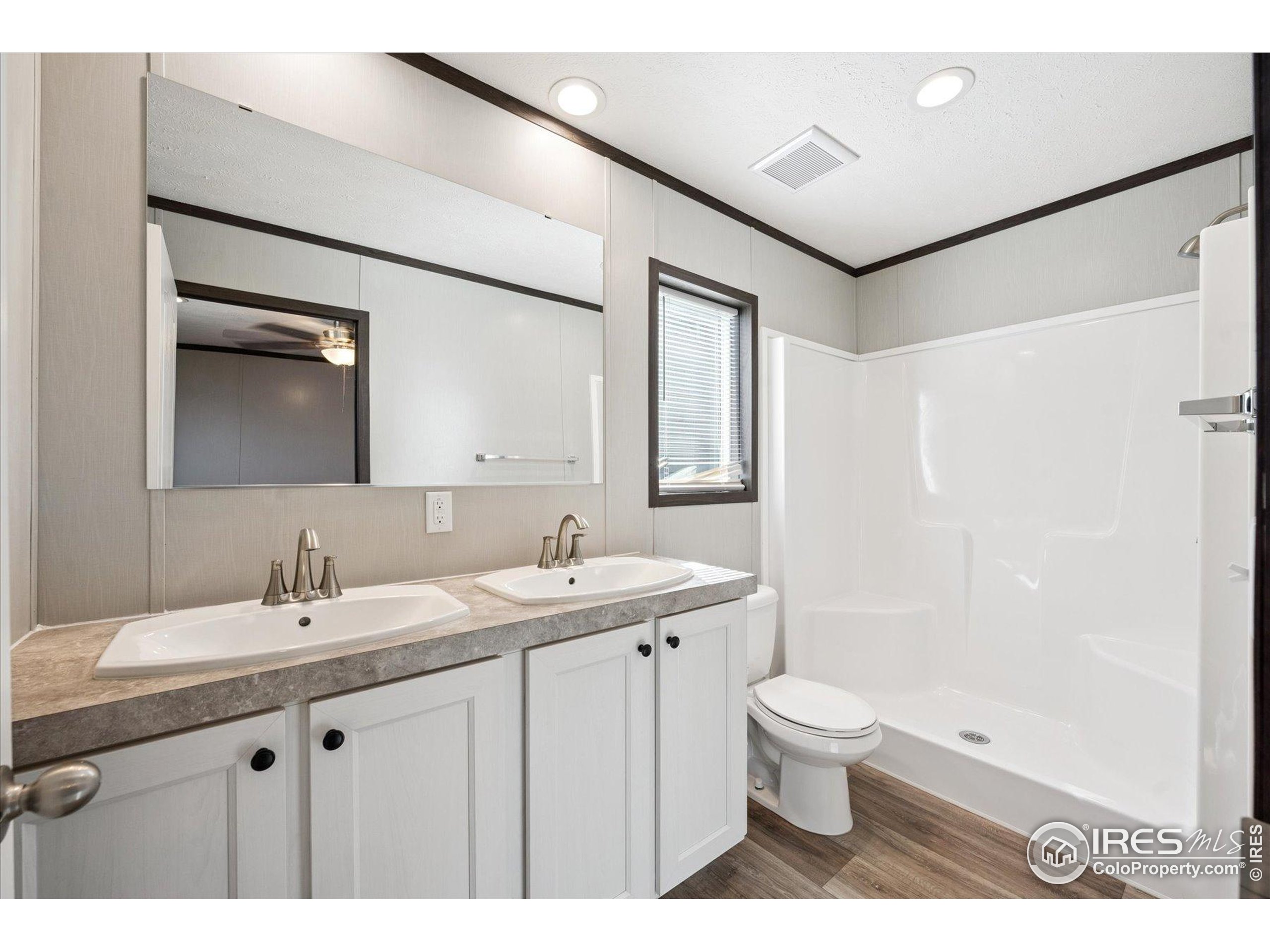 830 1st Street, Unit 2 Pierce, CO 80650 - Photo 15 of 16 a bathroom with a sink a toilet and a mirror