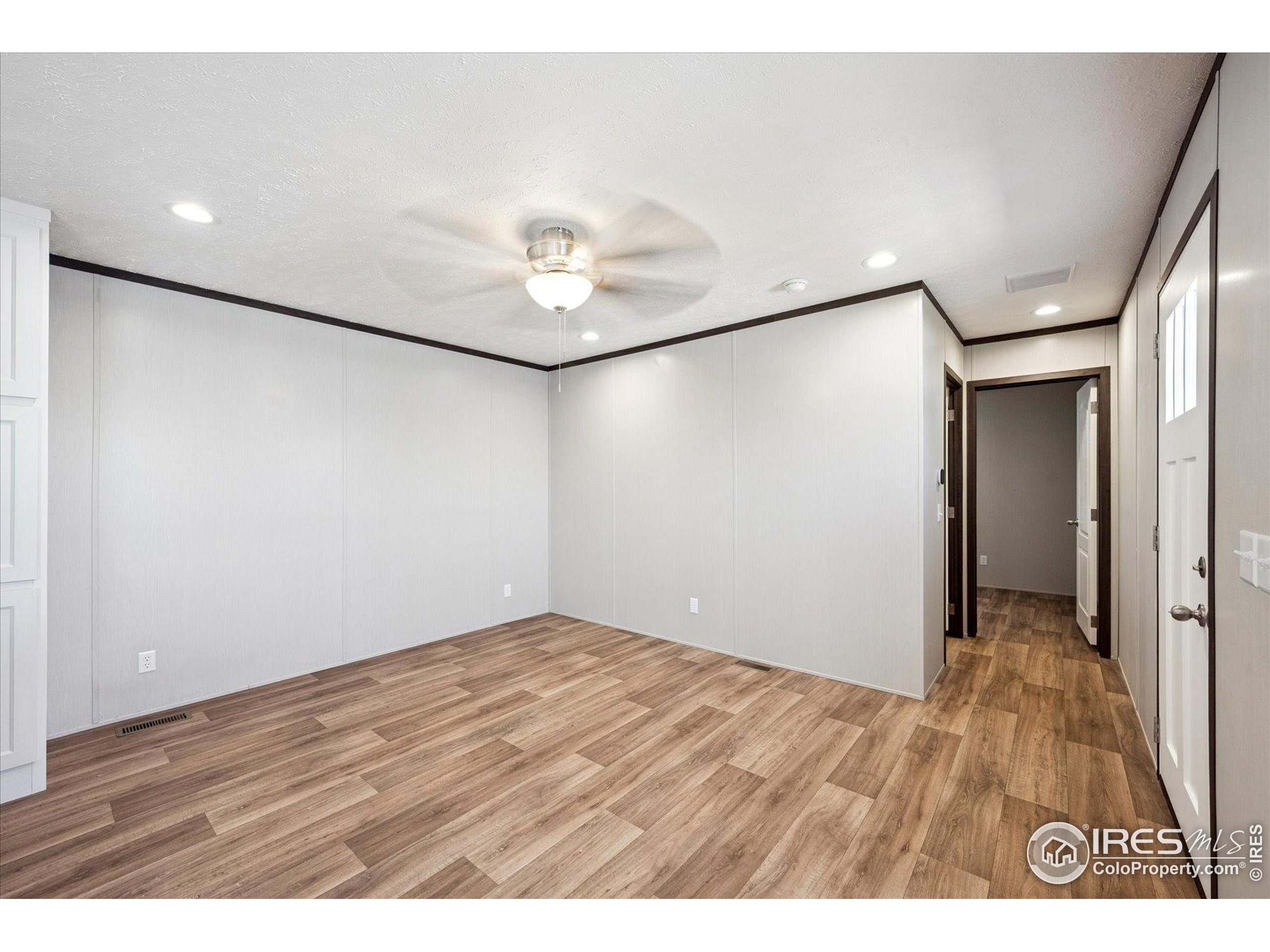 830 1st Street, Unit 2 Pierce, CO 80650 - Photo 4 of 16 a view of an empty room with wooden floor