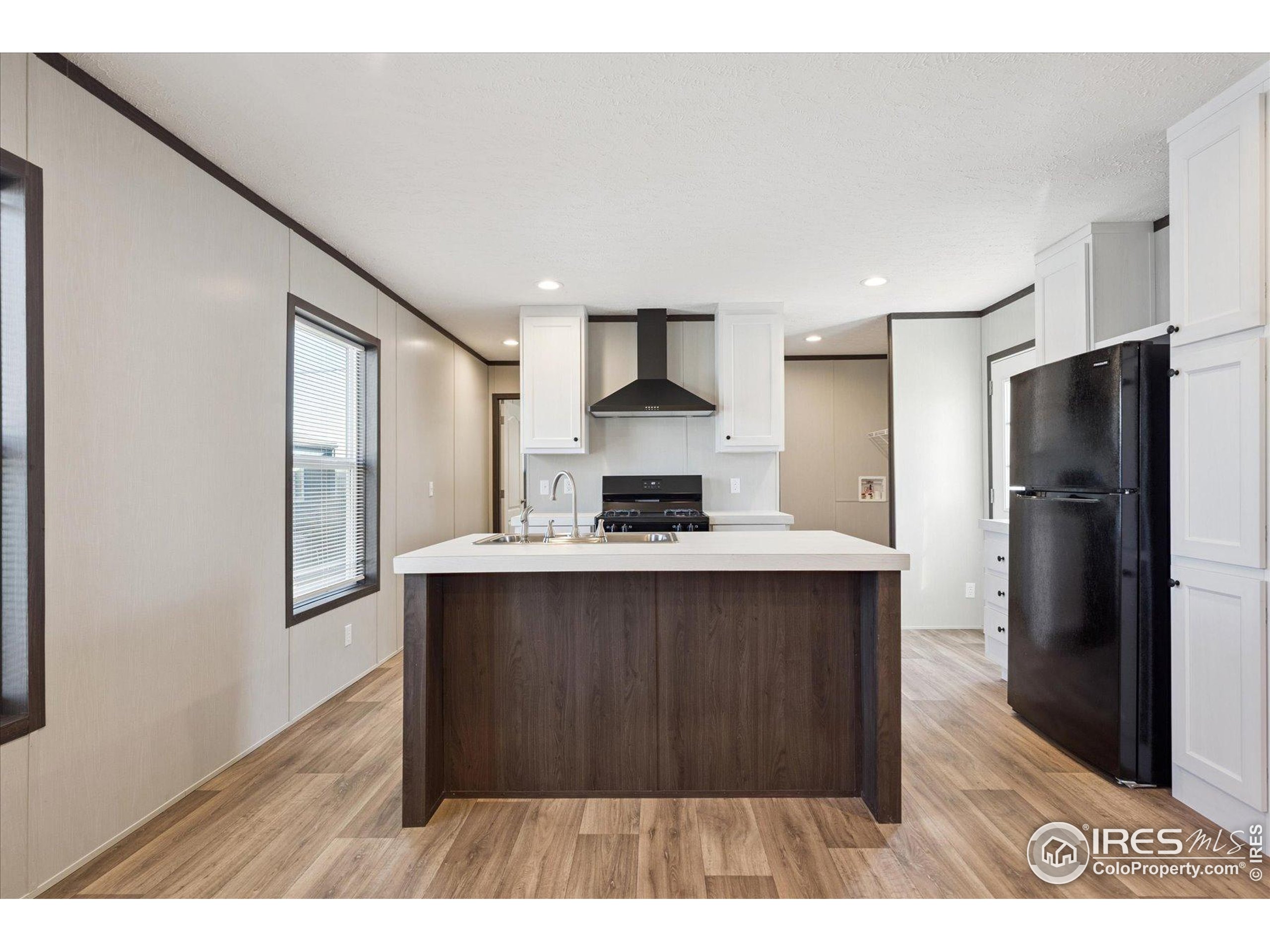 830 1st Street, Unit 2 Pierce, CO 80650 - Photo 5 of 16 a kitchen with stainless steel appliances a refrigerator and a stove top oven