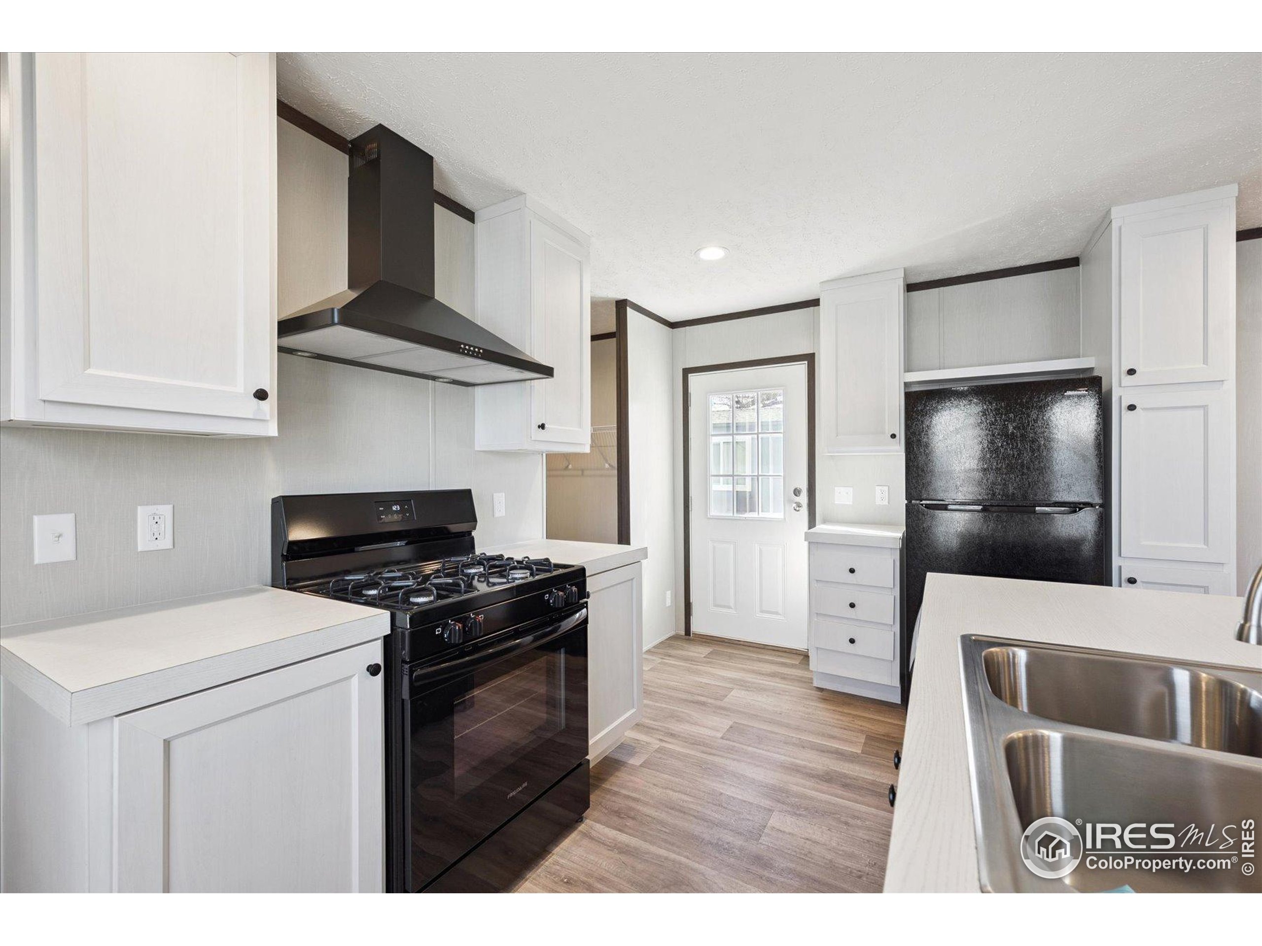 830 1st Street, Unit 2 Pierce, CO 80650 - Photo 6 of 16 a kitchen with stainless steel appliances a stove and a microwave