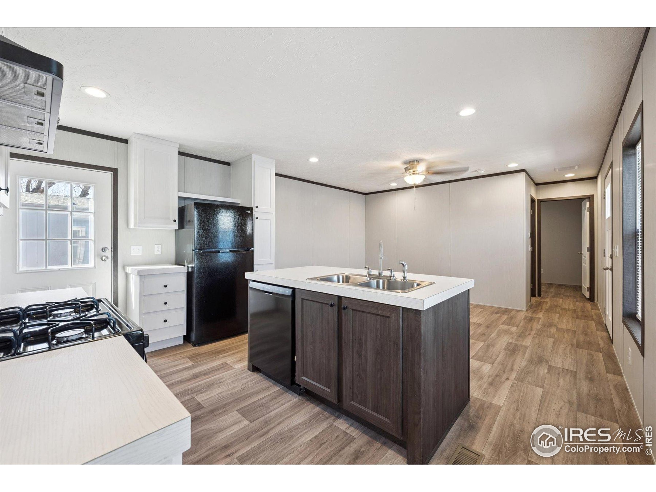 830 1st Street, Unit 2 Pierce, CO 80650 - Photo 9 of 16 a kitchen with stainless steel appliances a refrigerator and a stove