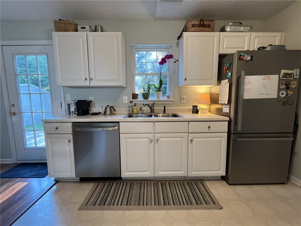 116 Arbors Court Central, SC 29630 - Photo 8 of 27 A well-equipped kitchen features white cabinetry and stainless steel appliances for daily convenience.
