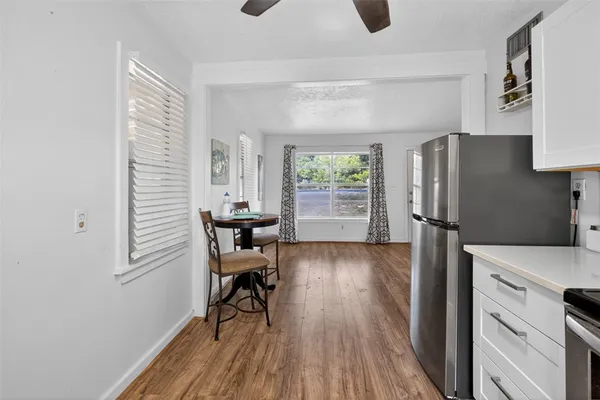 a kitchen with stainless steel appliances granite countertop a refrigerator and a stove top oven