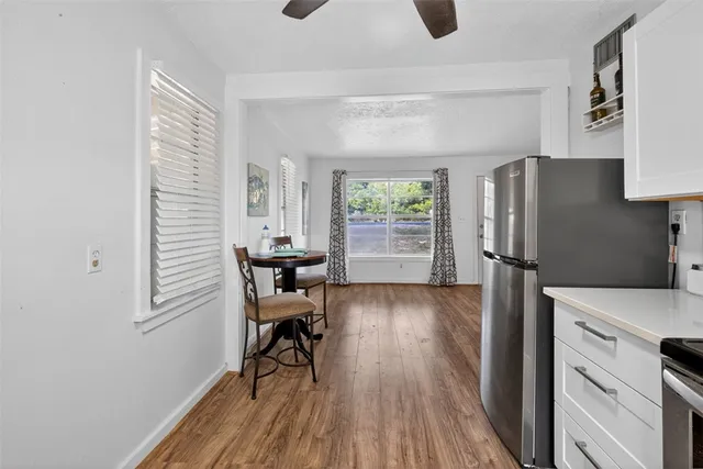 a kitchen with stainless steel appliances granite countertop a refrigerator and a stove top oven