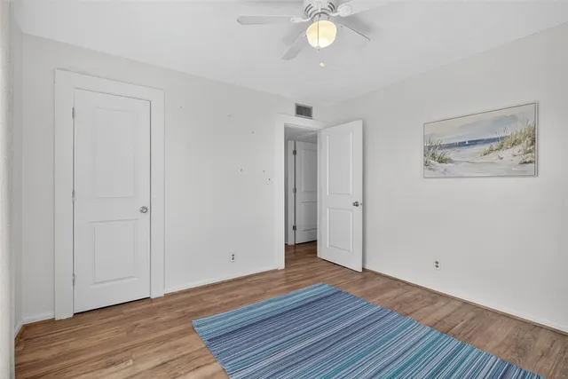 a view of a room with wooden floor