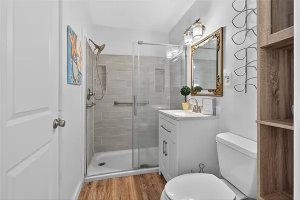 a bathroom with a toilet a sink and shower