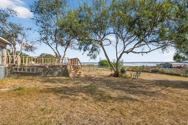 a backyard of a house with table and chairs