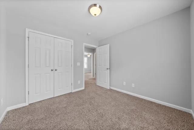 a bathroom with a bathtub shower sink vanity mirror and toilet