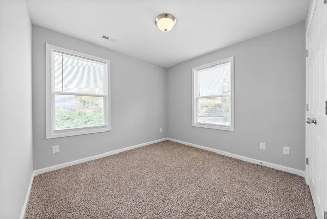 a view of an empty room with closet area