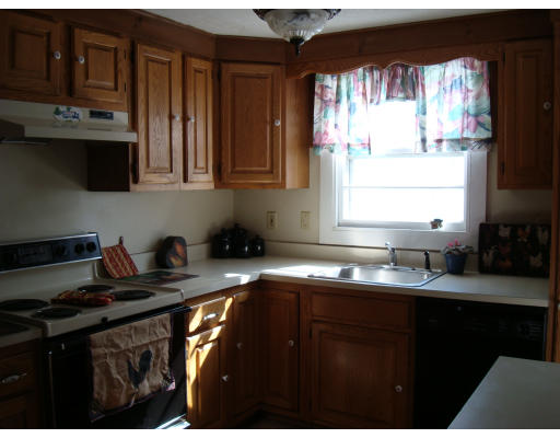 17 Lancaster Street Springfield, MA 01118 - Photo 4 of 15 a kitchen with granite countertop a sink a stove and cabinets
