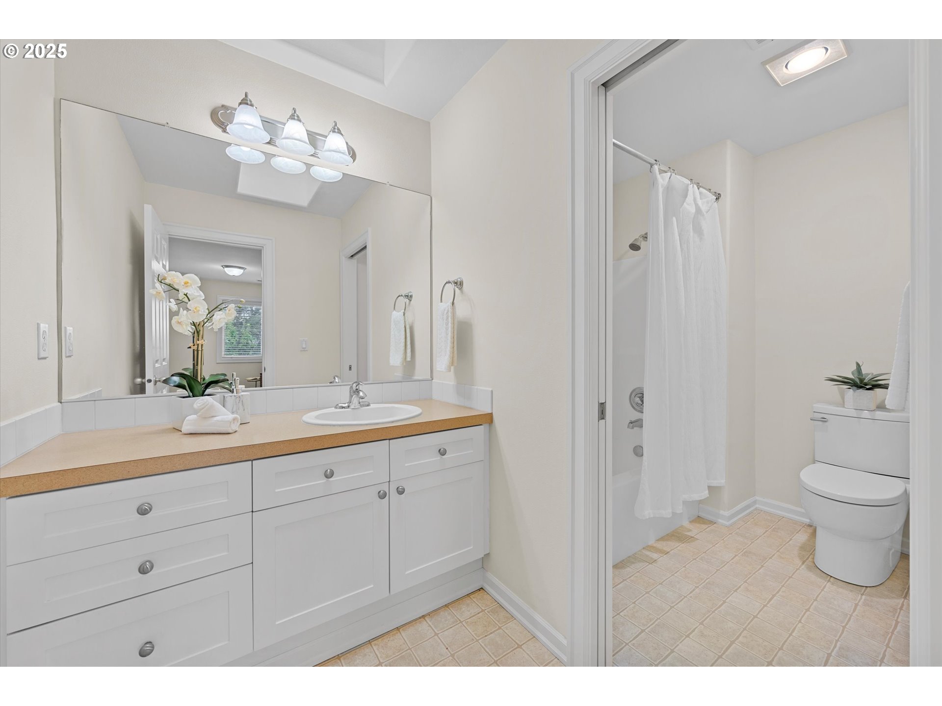 2926 Southwest Texas Street Portland, OR 97219 - Photo 12 of 16 a bathroom with a sink a toilet and a large mirror