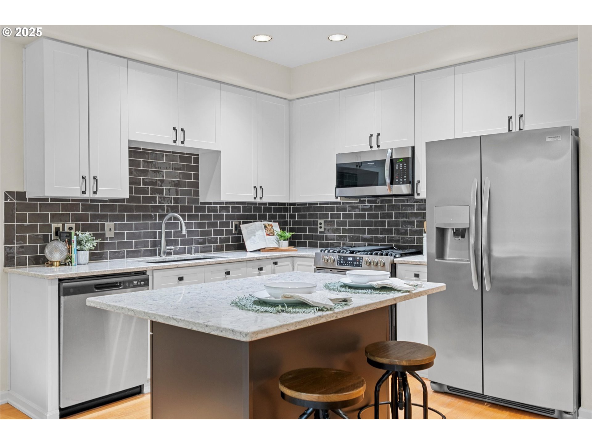 2926 Southwest Texas Street Portland, OR 97219 - Photo 5 of 16 a kitchen with stainless steel appliances a stove a sink a refrigerator and cabinets