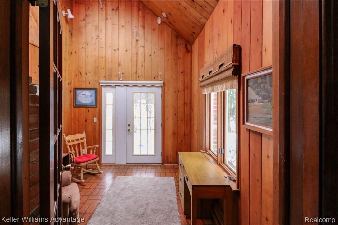 4679 Hegel Road Goodrich, MI 48438 - Photo 18 of 41 Unique sitting room has an impressive sky-high ceiling with beautiful pine walls.