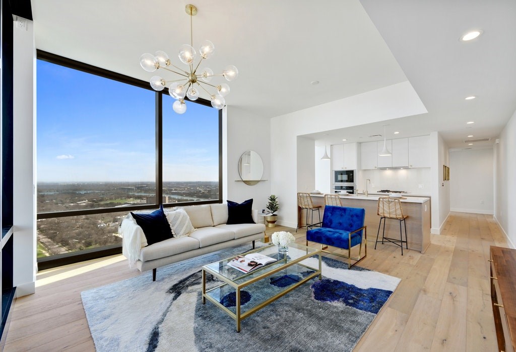 a living room with furniture a rug and a chandelier