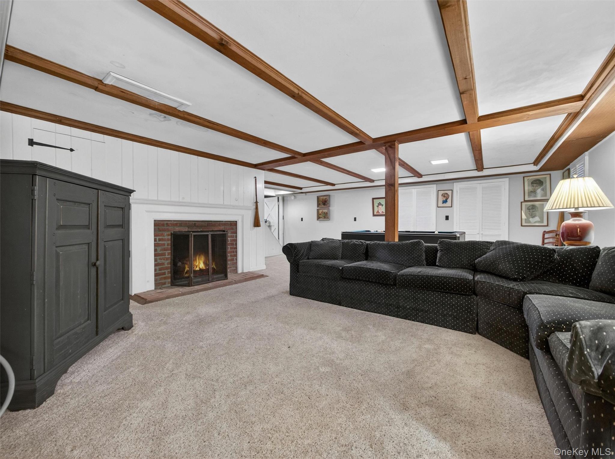 56 Oak Road New City, NY 10956 - Photo 25 of 30 a living room with furniture a fireplace and a large window