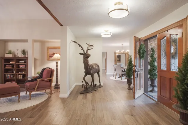 a kitchen with a dining table chairs stainless steel appliances and cabinets