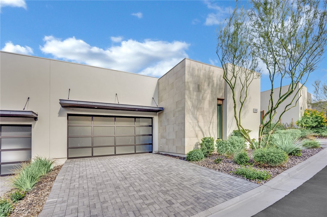 658 Falcon Summit Court Henderson, NV 89012 - Photo 2 of 99 Modern home with decorative driveway, stucco siding, and an attached garage