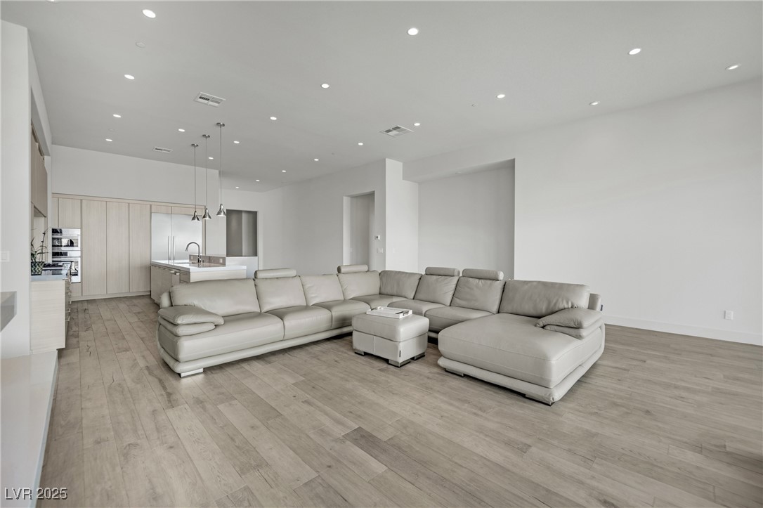 658 Falcon Summit Court Henderson, NV 89012 - Photo 20 of 99 Living area featuring recessed lighting and light wood-type flooring