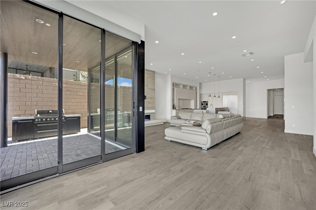 658 Falcon Summit Court Henderson, NV 89012 - Photo 21 of 99 Living room featuring recessed lighting, light wood-type flooring, and expansive windows