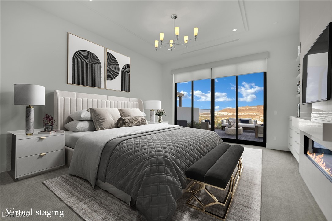 658 Falcon Summit Court Henderson, NV 89012 - Photo 26 of 99 Carpeted bedroom featuring a glass covered fireplace, access to outside, and a chandelier