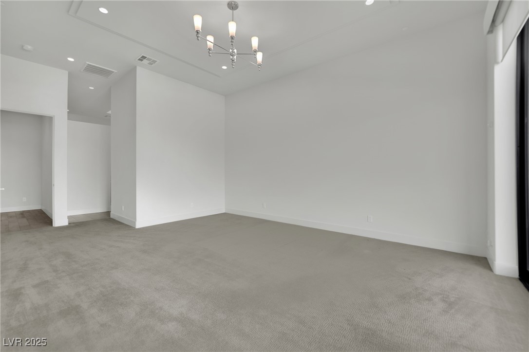 658 Falcon Summit Court Henderson, NV 89012 - Photo 27 of 99 Unfurnished room featuring light carpet, recessed lighting, and a chandelier