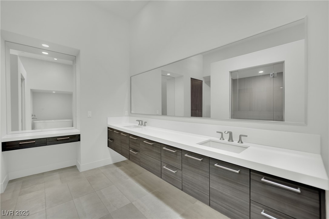 658 Falcon Summit Court Henderson, NV 89012 - Photo 33 of 99 Bathroom with double vanity, recessed lighting, and light tile patterned flooring