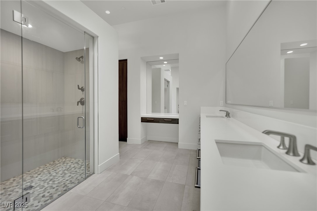 658 Falcon Summit Court Henderson, NV 89012 - Photo 35 of 99 Bathroom with a shower stall, light tile patterned floors, double vanity, and recessed lighting
