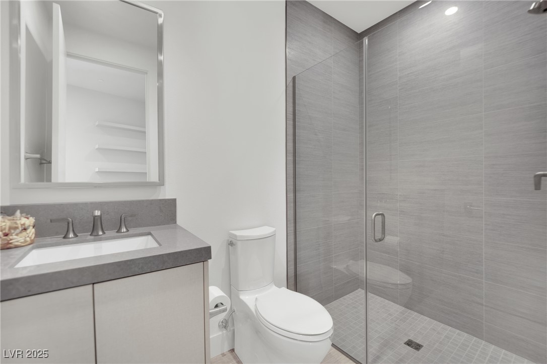 658 Falcon Summit Court Henderson, NV 89012 - Photo 42 of 99 Bathroom with a stall shower and vanity