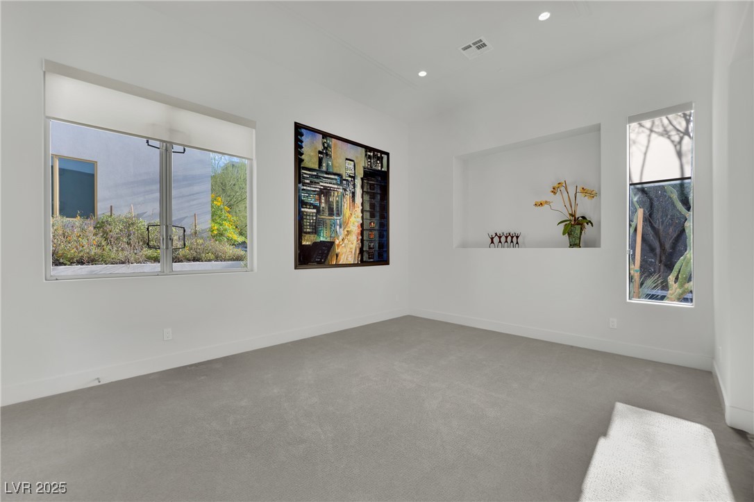 658 Falcon Summit Court Henderson, NV 89012 - Photo 43 of 99 Unfurnished room featuring carpet flooring and recessed lighting